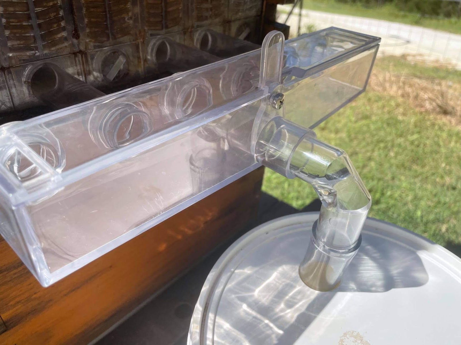 Mainstar BeeHive Manifold connected to a honey collection bucket